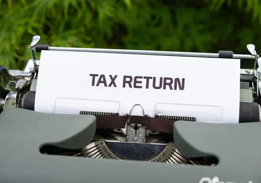 Laptop and documents for tax return decisions